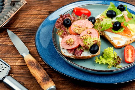 Photo for Open sandwiches with salted salmon and sausages for breakfast - Royalty Free Image
