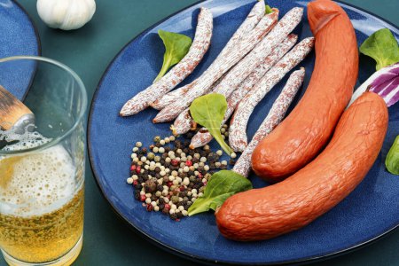 Photo for Smoked kabanos sausages, prepared from mixed minced. Dry smoked sausages, salami, kabanos and cold beer. - Royalty Free Image