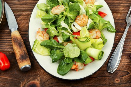 Photo for Plate with salad of fresh vegetables, herbs and shrimp. Prawn salad on wooden table - Royalty Free Image
