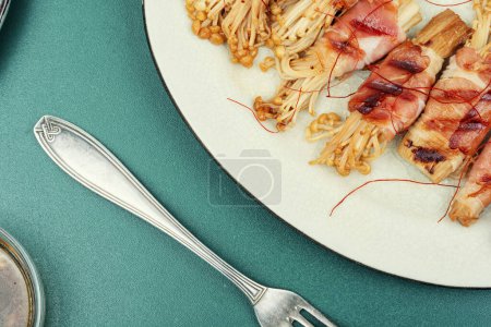 Photo for Enoki mushrooms appetizer fried in bacon. Asian diet meal. Delicious Japanese dish. - Royalty Free Image