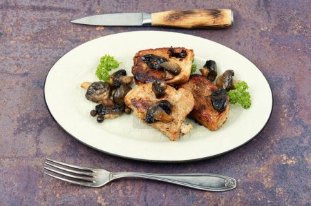 Photo for Roasted pork medallions steaks from tenderloin fillet with mushrooms on a plate. - Royalty Free Image