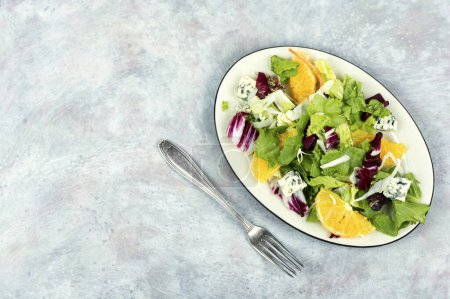 Photo for Plate with healthy salad with mix leaves, orange and cheese. Top view. Copy space. - Royalty Free Image