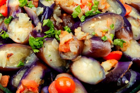 Photo for Warm purple eggplant, tomato and garlic salad. Close up - Royalty Free Image