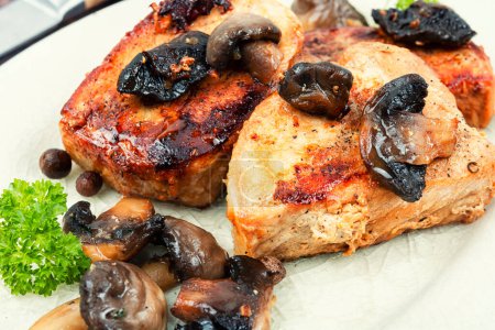 Photo for Roasted juicy pork medallions steaks from tenderloin fillet with mushrooms on a plate. - Royalty Free Image