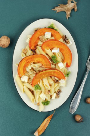 Photo for Seasonal autumn dish, pasta with roasted pumpkins and nuts. Flat lay. - Royalty Free Image