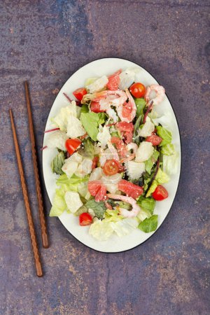 Photo for Pomelo salad with shrimp, tomatoes and lettuce on a plate. Seafood salad. - Royalty Free Image