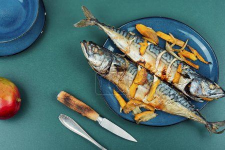 Photo for Appetizing mackerel fish roasted with mango. Food recipe background. Top view. - Royalty Free Image