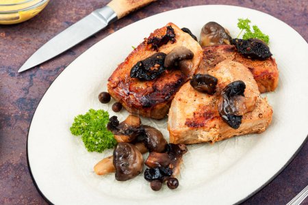 Photo for Pork tenderloin fillet meat medallions with mushrooms on a plate. - Royalty Free Image