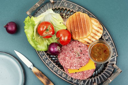 Photo for Raw burger patties, cheese, vegetables and burger buns for cooking. Raw steak cutlets with mince meat. - Royalty Free Image