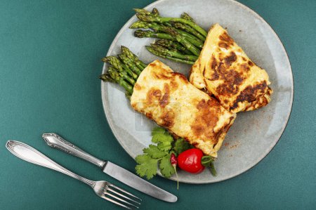 Photo for Egg omelet with asparagus and greens. Top view - Royalty Free Image