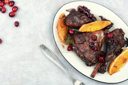 Photo for Roasted chicken legs, drumsticks with orange, spices and red berries. Space for text. - Royalty Free Image