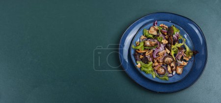 Téléchargez les photos : Salade de légumes aux champignons de forêt grillés, oignons, herbes et noix. Vue du dessus, espace de copie. - en image libre de droit