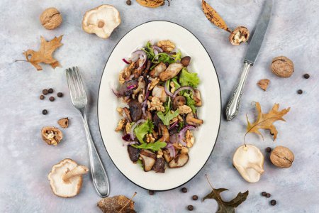 Photo for Vegetable salad with grilled forest mushrooms, onions, herbs and walnuts. Top view. - Royalty Free Image