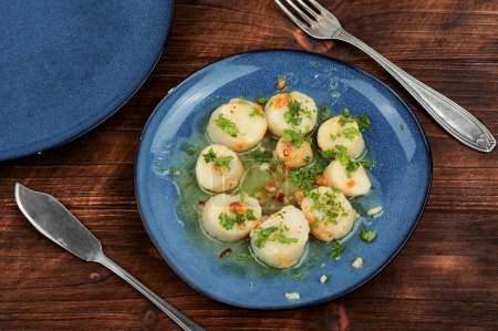 Photo for Fried delicious scallops with green on a plate - Royalty Free Image