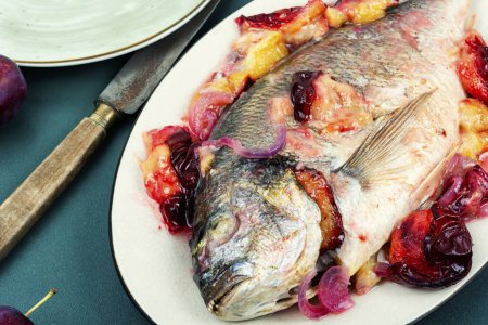 Photo for Dorado or sea bream fish baked with plums. Gilthead fishes - Royalty Free Image