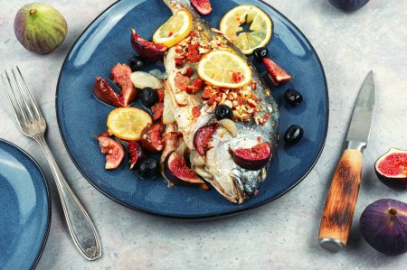 Photo for Whole grilled or baked whole dorado fish with lemon, almonds and figs. Autumn recipe. - Royalty Free Image