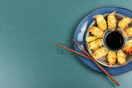 Photo for Roasted rolled potato shrimps, prawns and potato rolls. Asian food. Space for text. - Royalty Free Image