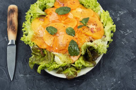 Photo for Salad with green lettuce, fresh persimmon and mint. Healthy diet food. Vegan food. - Royalty Free Image