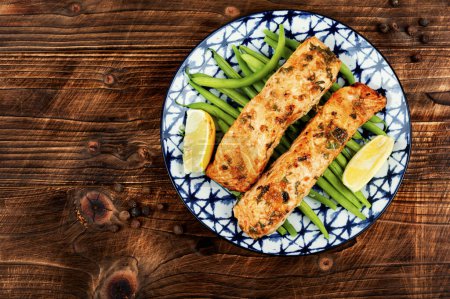 Photo for Grilled salmon fish with bush green beans on rustic wooden table. Space for text. - Royalty Free Image