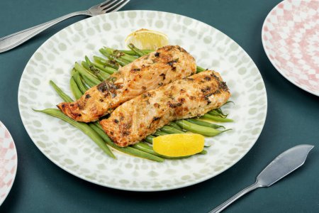 Photo for Delicious baked salmon steaks with green beans and and fresh lemon. Keto diet healthy food. - Royalty Free Image