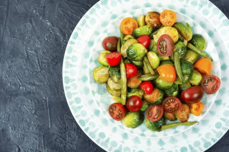 Photo for Vegetarian salad of roasted Brussels sprouts, tomatoes and green beans. Copy space. - Royalty Free Image