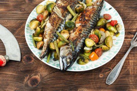 Photo for Roasted scomber fish with tomatoes, cabbage and green beans on dark wooden background - Royalty Free Image