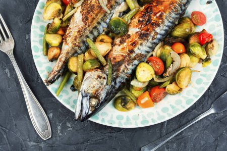 Photo for Grilled baked mackerel fish and tomatoes, cabbage and green beans on stone background. - Royalty Free Image