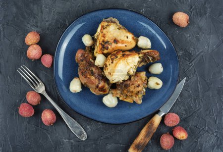Photo for Pieces of baked mustard glazed chicken with lychee on a plate. Top view. - Royalty Free Image