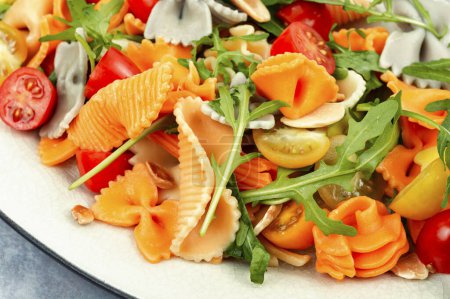 Photo for Salad with fresh tomatoes, herbs and pasta on a plate. Close up. - Royalty Free Image