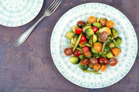 Photo for A platter of salad of fried Brussels sprouts, tomato and green bush beans. Space for text. - Royalty Free Image