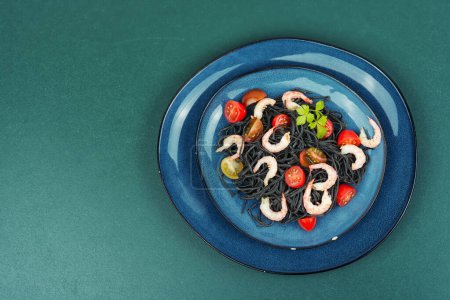 Photo for Delicious vegetarian black spaghetti with prawn and tomatoes. Healthy food concept. Copy space. - Royalty Free Image
