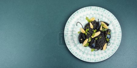 Photo for Vegan black bean pasta with mussels. Spaghetti with seafood. Pasta vongole. Space for text. - Royalty Free Image