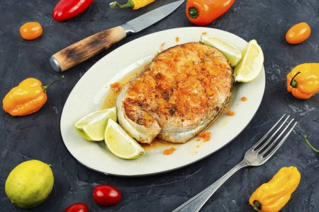 Photo for Plate of roasted trout steak with orange sauce. Keto diet. - Royalty Free Image