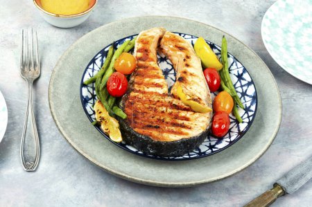 Photo for Fried salmon steak and vegetable salad. Grilled fish. - Royalty Free Image