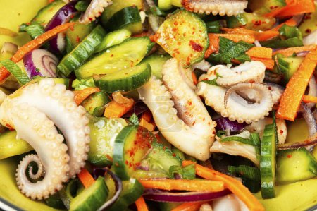Photo for Salad of cucumber, onion and tentacles octopus. Healthy seafood salad. Healthy food, dieting, close up. - Royalty Free Image