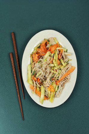 Photo for Plate with salad of enoki mushrooms and vegetables. National Chinese food. Top view. - Royalty Free Image