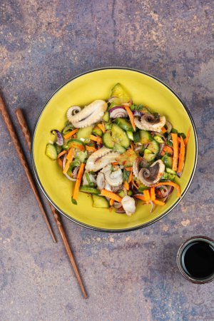 Téléchargez les photos : Salade de calmar, concombre, oignon et poulpe. Cuisine coréenne aux fruits de mer - en image libre de droit