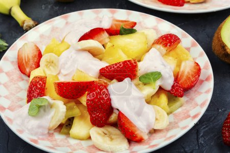 Photo for Fruit vitamin salad of pineapple, strawberries, kiwi and yogurt. Healthy natural organic food. - Royalty Free Image