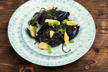 Photo for Vegan black bean pasta with mussels or clams. Mediterranean pasta vongole. - Royalty Free Image