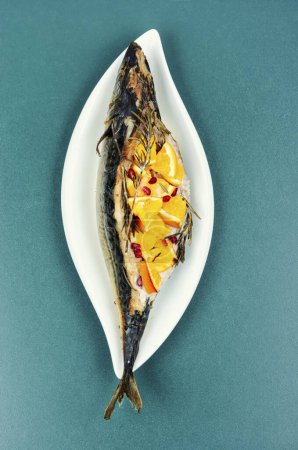 Photo for Delicious grilled mackerel fish with oranges and rosemary served on a stylish plate. - Royalty Free Image