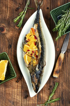 Photo for Mackerel fish baked with oranges and rosemary on a vintage wooden background. - Royalty Free Image
