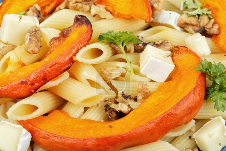 Photo for Pasta or macaroni with baked pumpkins and nuts. Tasty autumn food, macro. - Royalty Free Image