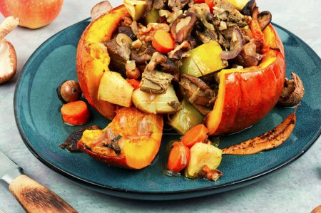 Photo for Autumn roasted pumpkin stuffed with beef meat, mushrooms, apple and carrots. - Royalty Free Image