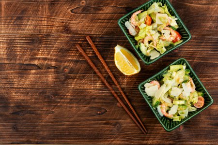 Photo for Asian salad with shrimp,prawns and avocado slices on a vintage wooden background. Healthy eating. Space for text. - Royalty Free Image