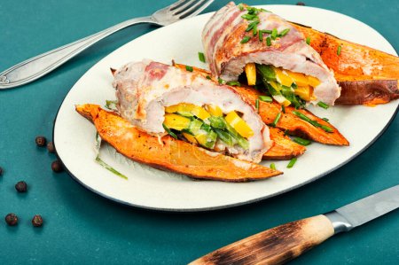 Photo for Roast pork meat roll and baked sweet potatoes. - Royalty Free Image