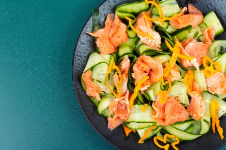 Asian salad with smoked salmon and fresh cucumber. Space for text.