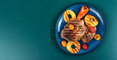 Photo for Grilled meat with pineapple rings, grilled steak and ananas. Copy space. - Royalty Free Image