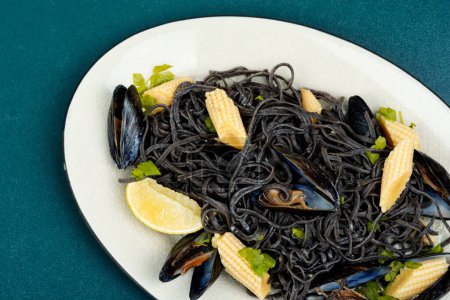 Photo for Vegan black bean pasta with mussels. Spaghetti with seafood. - Royalty Free Image