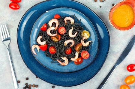 Photo for Vegetarian black bean spaghetti with prawn and tomatoes. Healthy food concept. - Royalty Free Image