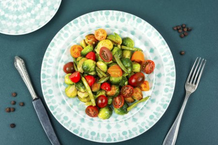 Photo for Warm salad of fried Brussels sprouts, tomato and green bush beans. - Royalty Free Image